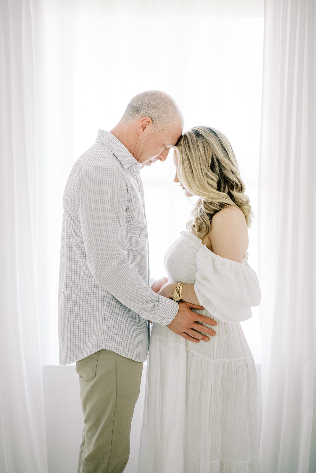 memphis maternity photography of expecting parents touching foreheads