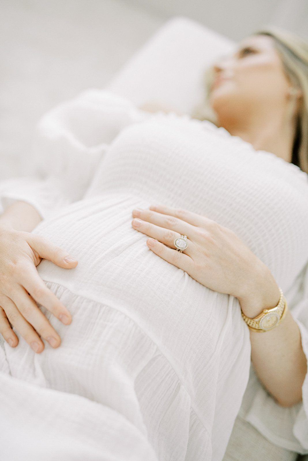 woman laying down holding pregnant belly taken by memphis maternity photographer
