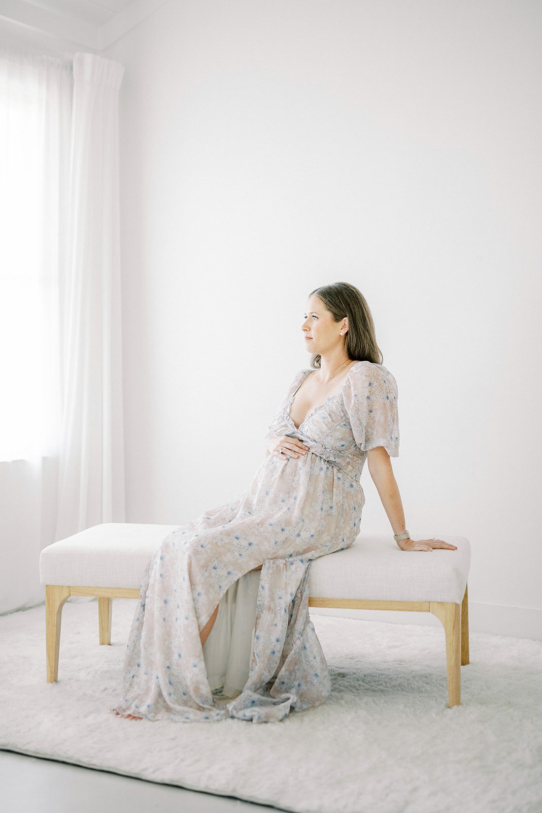 pregnant woman sitting on bench taken by memphis maternity photographer
