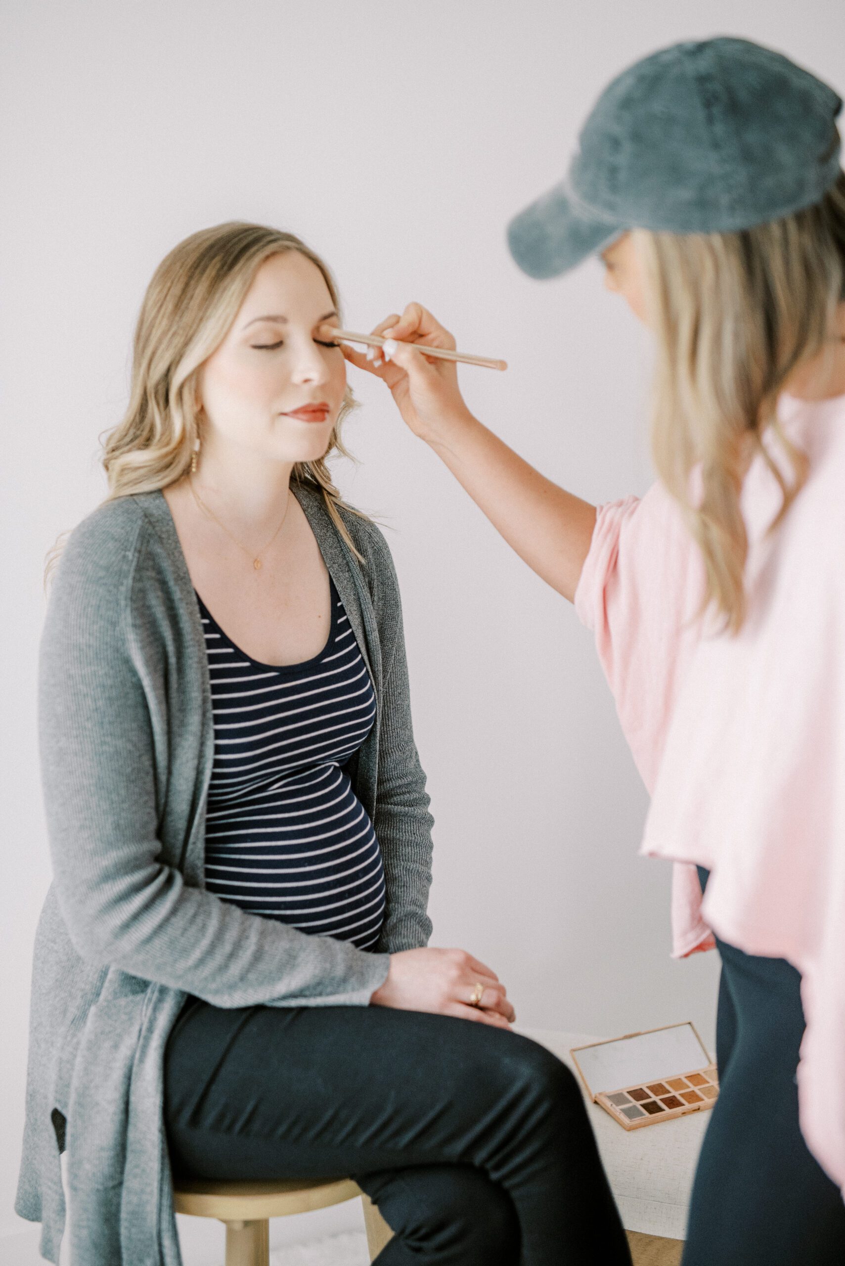 pregnant mom getting hair and makeup done for memphis maternity photos